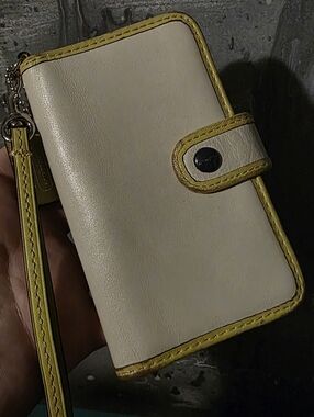 vintage Coach phone wallet case, typically designed for iPhone-